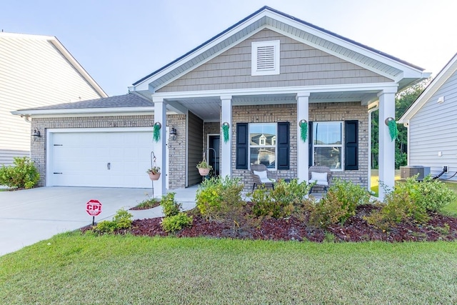 craftsman-style home with a porch, a garage, a front lawn, and cooling unit