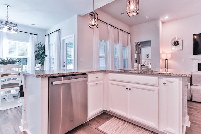 kitchen with dishwasher, light hardwood / wood-style flooring, pendant lighting, and white cabinets