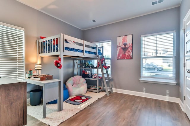 bedroom with wood-type flooring