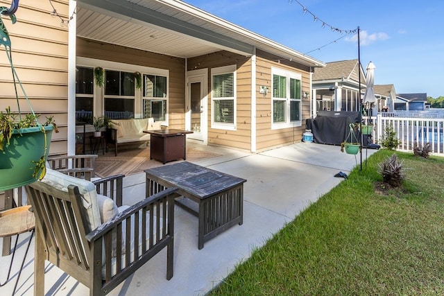 view of patio with an outdoor living space and a grill