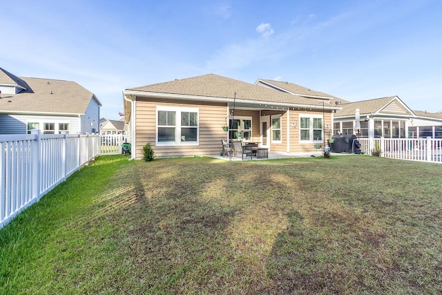 back of property with a patio and a lawn