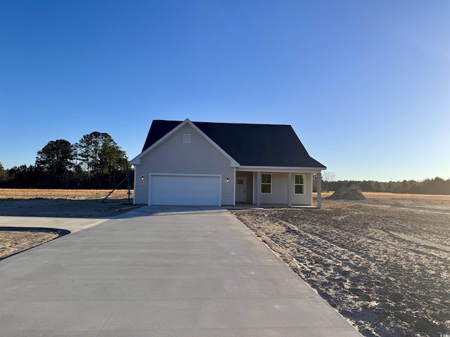 view of front of home with a porch and a garage