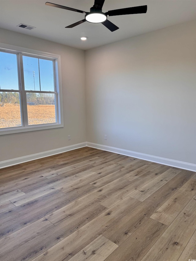 unfurnished room with ceiling fan and light hardwood / wood-style floors