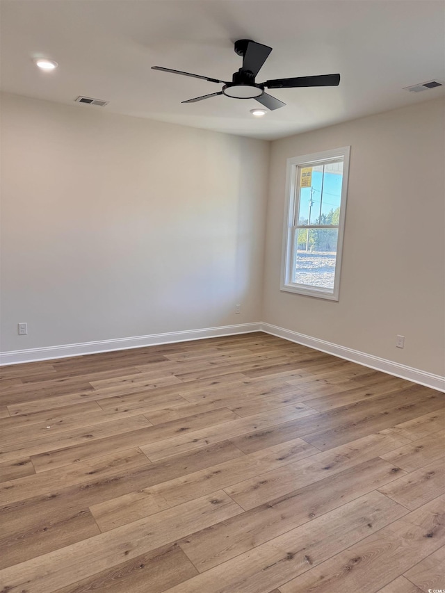 spare room with light hardwood / wood-style floors and ceiling fan