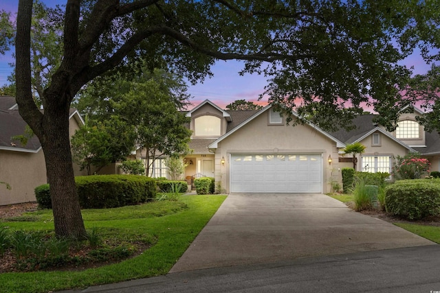 723 Antigua Dr, Myrtle Beach, SC 29572 - view of front of home with a garage, a yard, driveway, and stucco siding