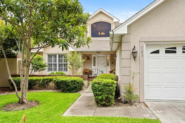 doorway to property with a yard