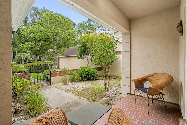 view of patio featuring fence and a gate