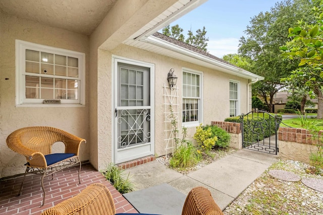 property entrance featuring stucco siding