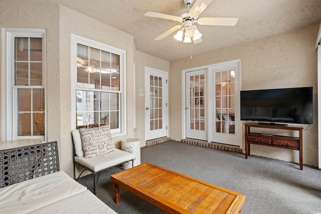 interior space with ceiling fan