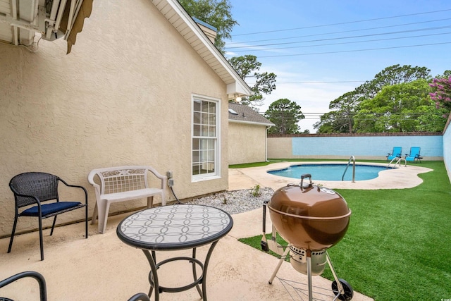 view of swimming pool featuring a patio and a lawn