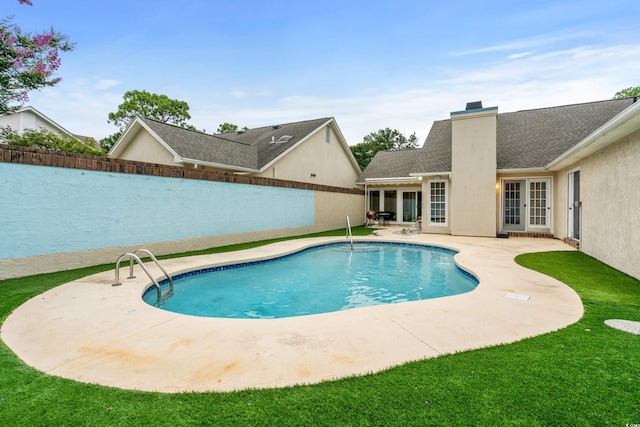 view of pool featuring a fenced in pool, french doors, a yard, a patio area, and a fenced backyard