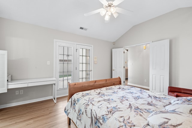 bedroom featuring ceiling fan, light hardwood / wood-style floors, and lofted ceiling