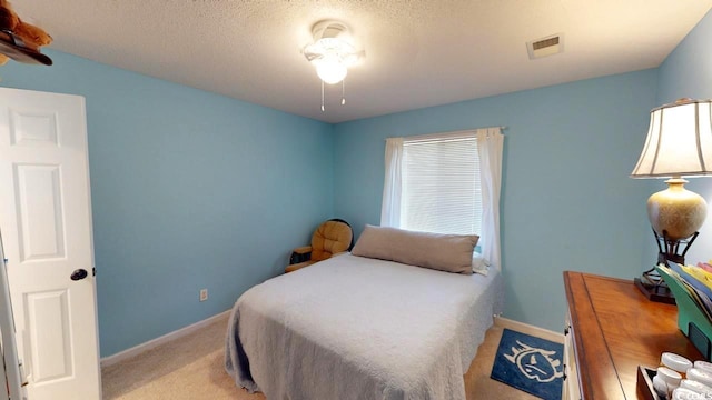 carpeted bedroom featuring a textured ceiling