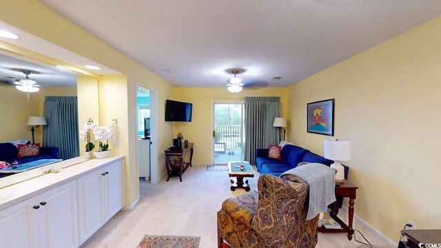 living room featuring light carpet and ceiling fan