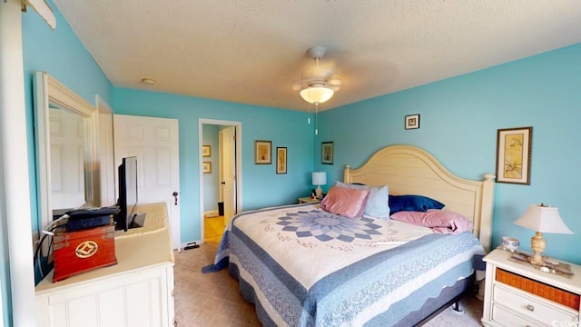 carpeted bedroom with a textured ceiling and ceiling fan