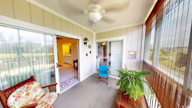 sunroom featuring ceiling fan