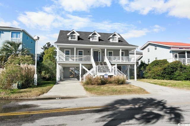 coastal inspired home featuring a carport and covered porch