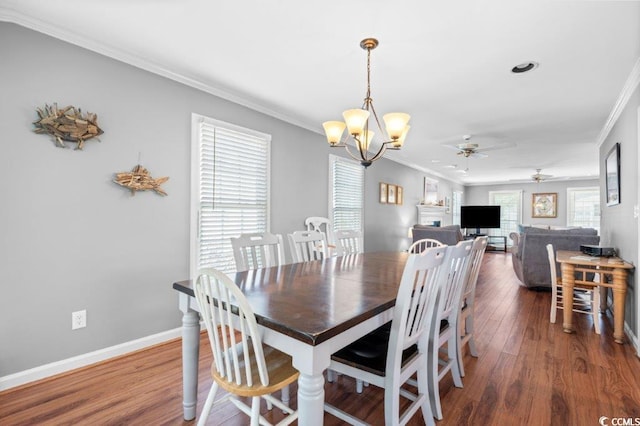 dining room featuring crown molding, dark hardwood / wood-style flooring, and ceiling fan with notable chandelier