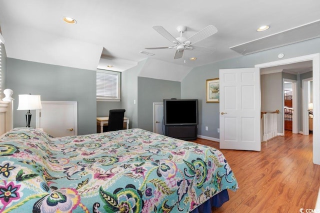 bedroom with ceiling fan, light hardwood / wood-style flooring, and lofted ceiling