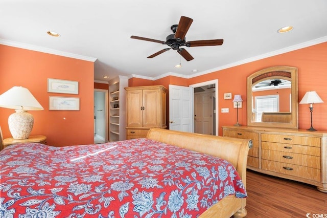 bedroom featuring ceiling fan, wood-type flooring, and ornamental molding