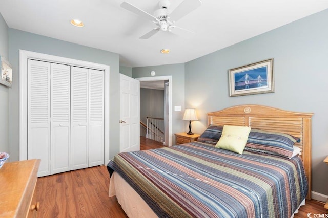 bedroom with hardwood / wood-style floors, a closet, and ceiling fan