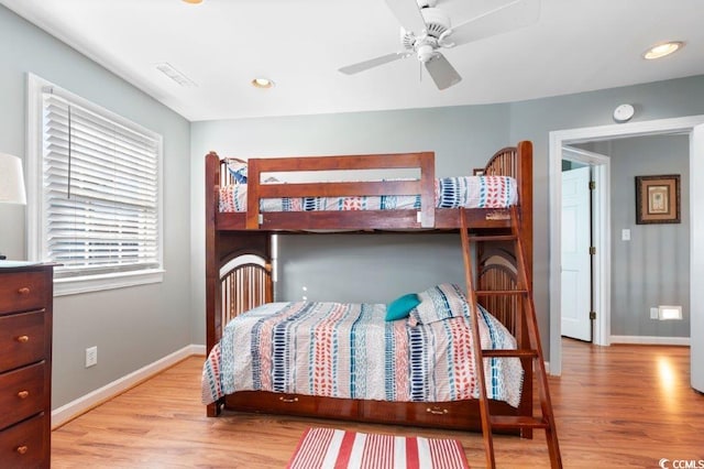 bedroom with ceiling fan and light hardwood / wood-style flooring