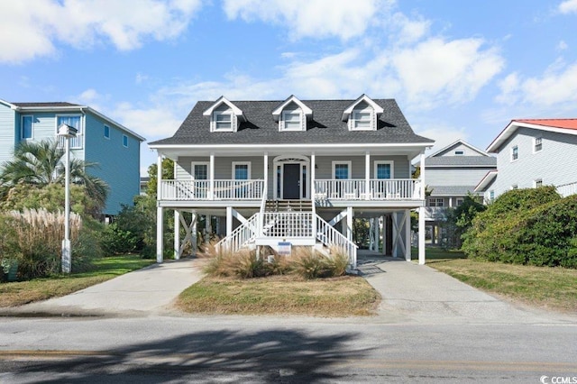 coastal inspired home with a porch and a carport