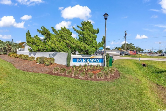 community sign featuring a yard