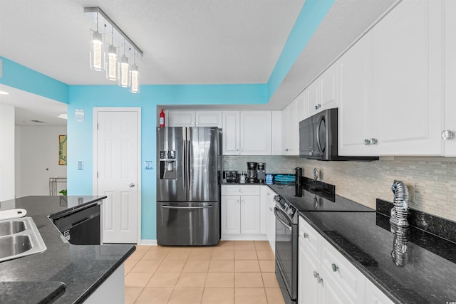 kitchen featuring light tile patterned flooring, dark stone counters, appliances with stainless steel finishes, decorative backsplash, and white cabinets