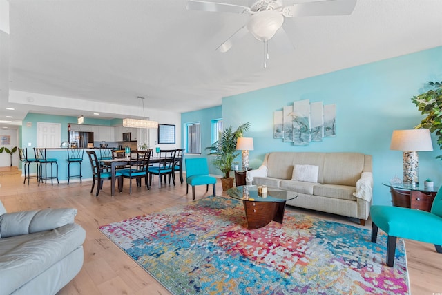 living room featuring light hardwood / wood-style floors and ceiling fan