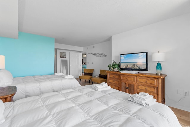 bedroom featuring light wood-type flooring and a closet