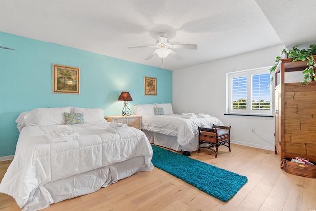 bedroom with ceiling fan and light hardwood / wood-style floors