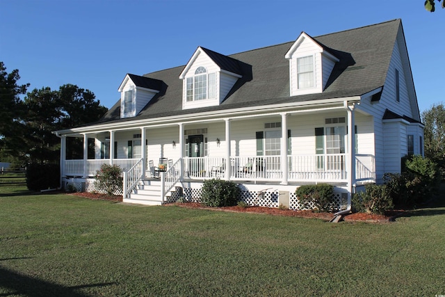 cape cod house featuring covered porch and a front lawn