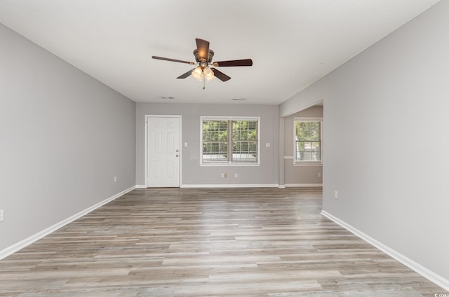 spare room featuring ceiling fan and light hardwood / wood-style floors