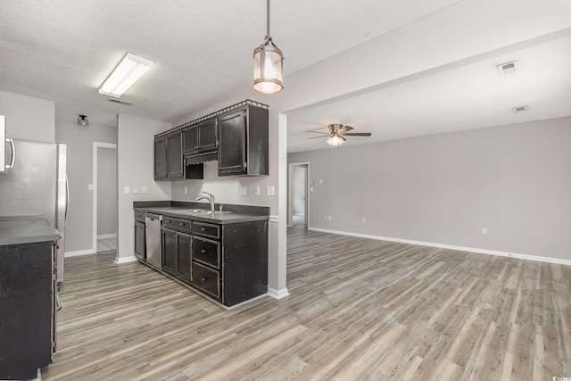 kitchen with sink, ceiling fan, appliances with stainless steel finishes, light hardwood / wood-style floors, and a textured ceiling