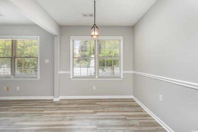 unfurnished dining area featuring light hardwood / wood-style floors