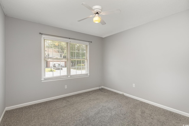 spare room with carpet and ceiling fan