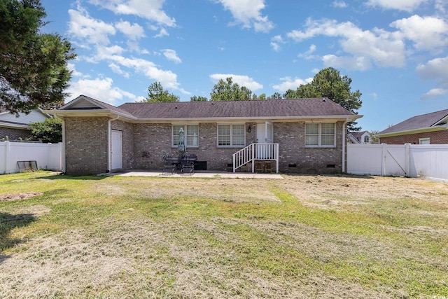 back of property featuring a yard and a patio