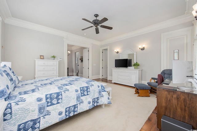 bedroom featuring ceiling fan, hardwood / wood-style flooring, and crown molding