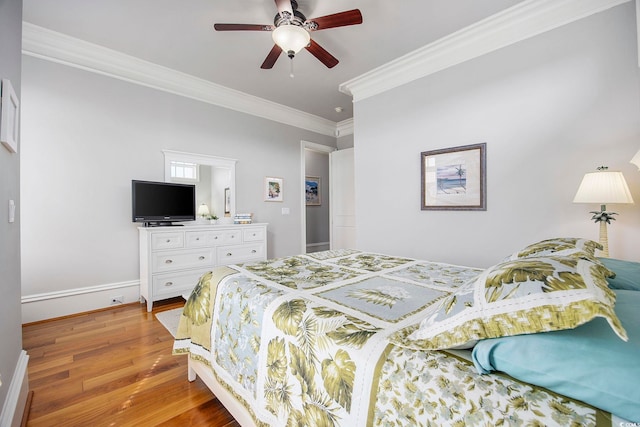 bedroom with wood-type flooring, ornamental molding, and ceiling fan