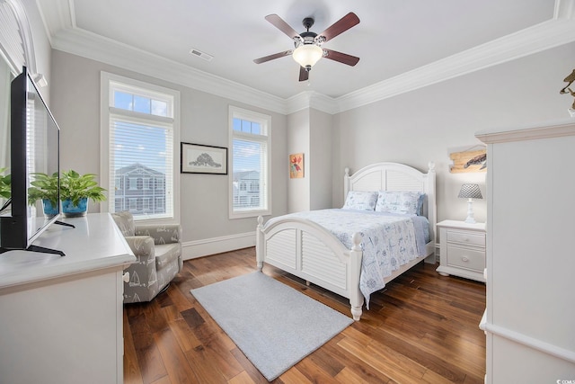 bedroom with crown molding, dark hardwood / wood-style flooring, and ceiling fan