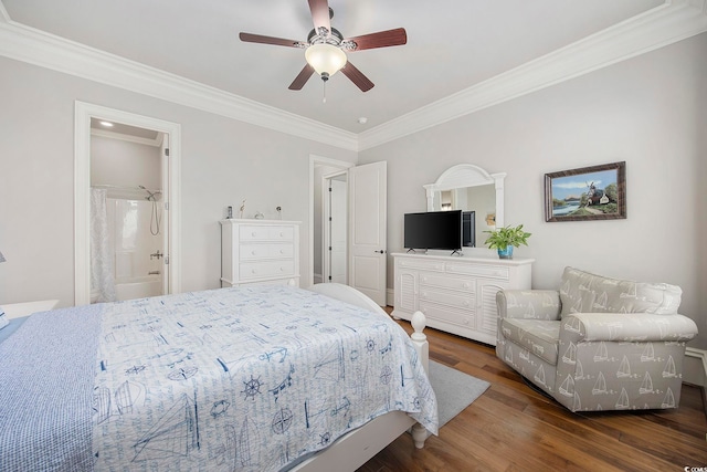 bedroom featuring ceiling fan, connected bathroom, dark hardwood / wood-style floors, and crown molding