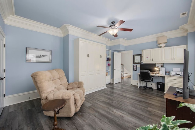 office featuring built in desk, crown molding, dark hardwood / wood-style flooring, and ceiling fan