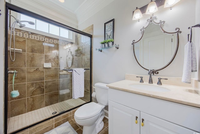 bathroom featuring ornamental molding, vanity, toilet, and an enclosed shower