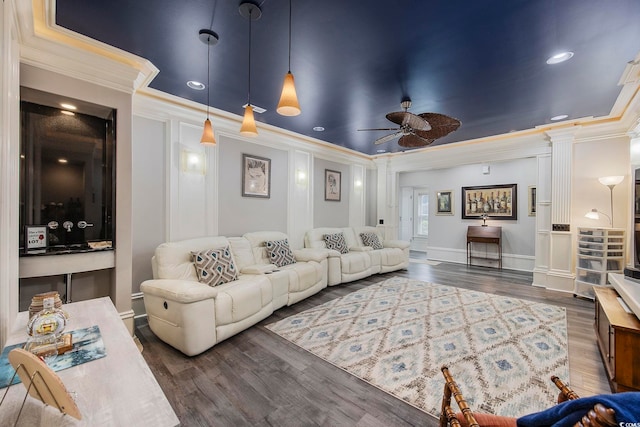 living room with ornamental molding, decorative columns, ceiling fan, and dark wood-type flooring