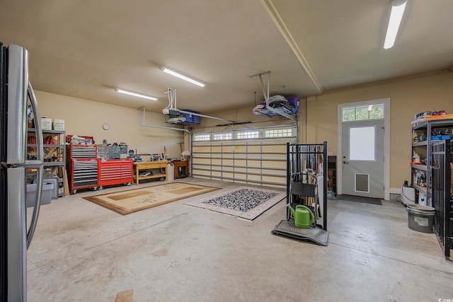 garage with a garage door opener and a workshop area