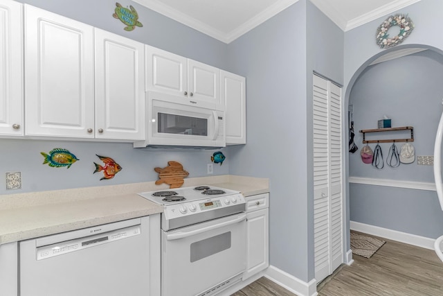 kitchen featuring crown molding, white cabinetry, light hardwood / wood-style flooring, and white appliances