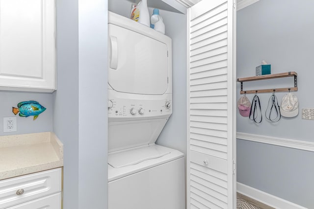 laundry room with stacked washing maching and dryer