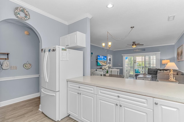 kitchen with white cabinetry, crown molding, ceiling fan, light hardwood / wood-style floors, and white refrigerator