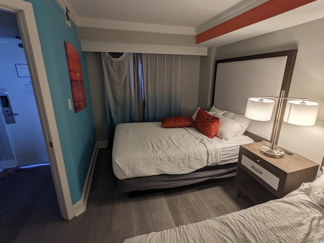 bedroom with wood-type flooring and crown molding